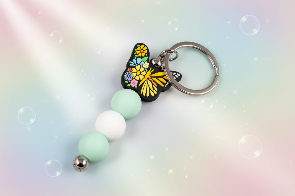Multicoloured butterfly charm keychain with green and white beads