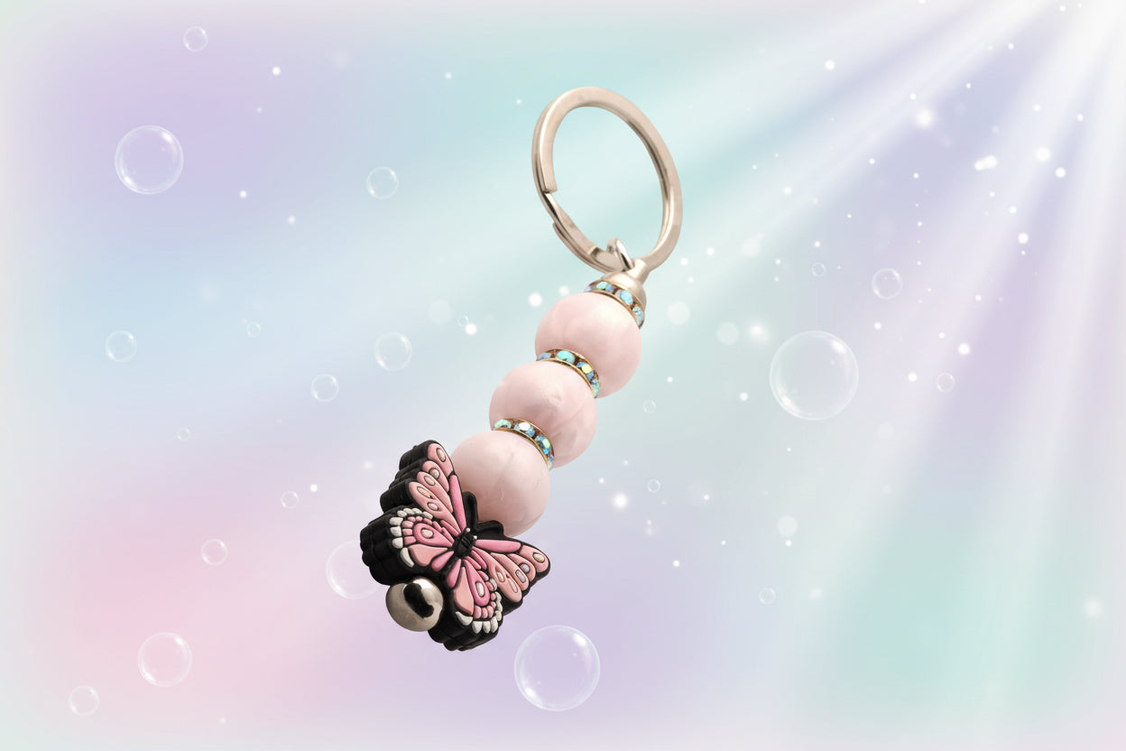 A pink butterfly charm keychain with pearlescent silicon beads and sparkly rondelles