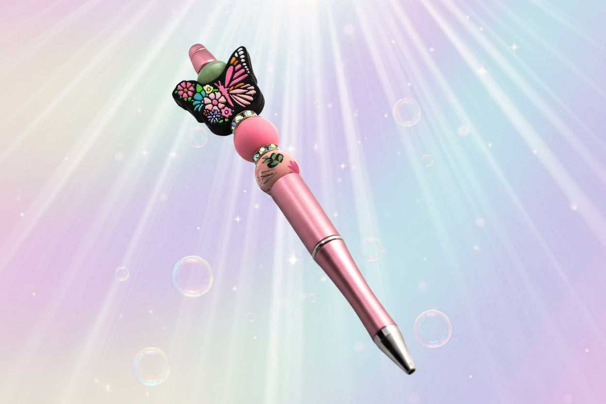 Pink pen with pink stacking silicon beads separated by glitter rondelles and a large butterfly silicon bead