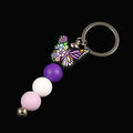 Multicoloured butterfly charm keychain with violet, white and purple beads 