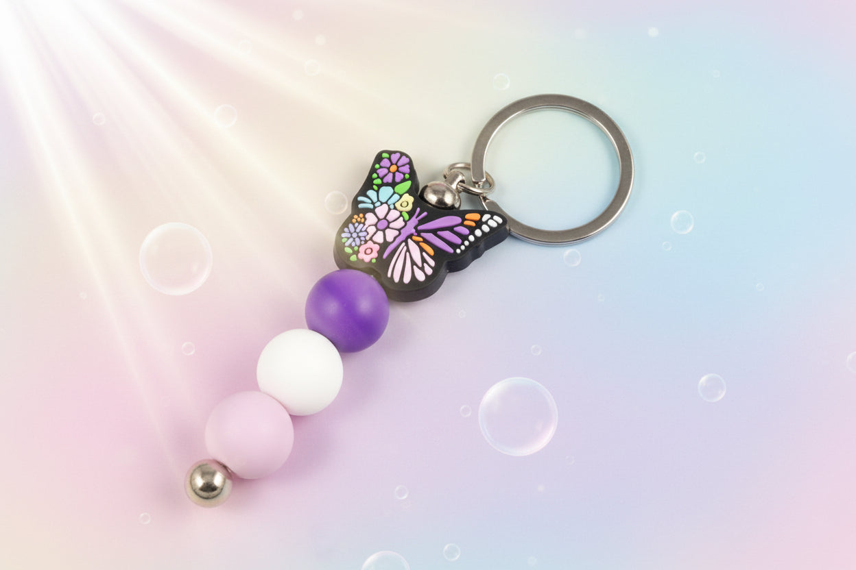 Multicoloured butterfly charm keychain with violet, white and purple beads 