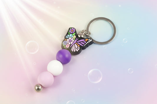 Multicoloured butterfly charm keychain with violet, white and purple beads 