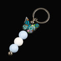 Multicoloured butterfly charm keychain with blue and white beads 