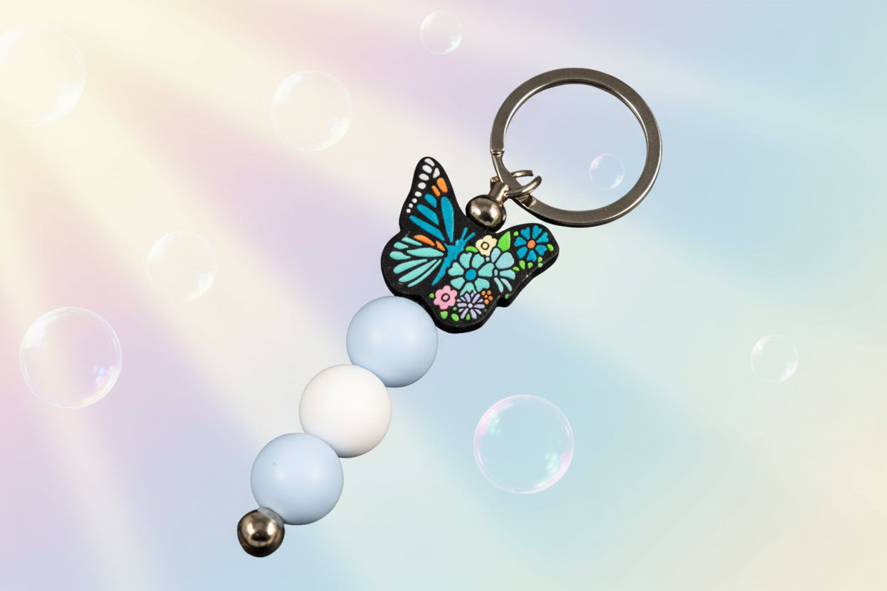 Multicoloured butterfly charm keychain with blue and white beads 