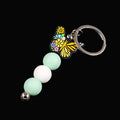 Multicoloured butterfly charm keychain with green and white beads 