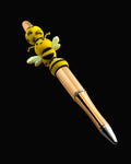 A gold pen with yellow beads with black stripes and  a bee pattern with black rondelles and a bee shaped bead