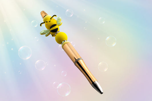 Gold pen with yellow stackable beads with sparkly rondelles and a bee shaped bead