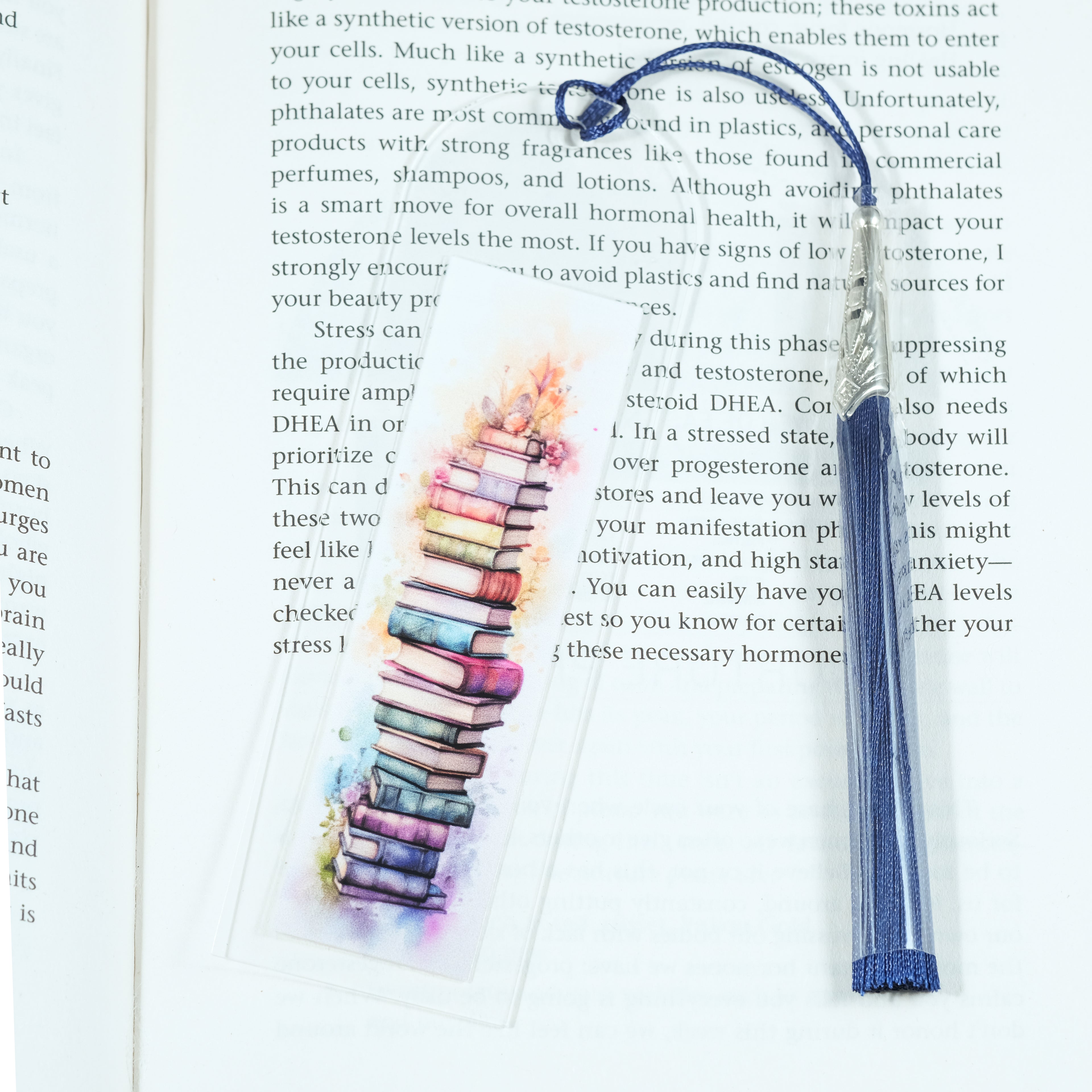 Mark your place in style! This cheerful acrylic bookmark features a delightful design of books and flowers that celebrates the joy of reading.