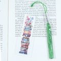 Mark your place in style! This cheerful acrylic bookmark features a delightful design of books and flowers that celebrates the joy of reading.