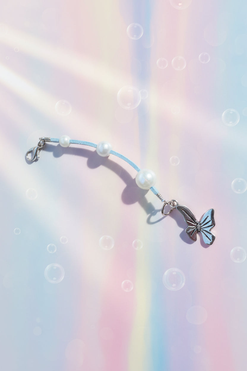 Add a touch of whimsy to your everyday carry with this beautiful handmade blue dangle charm. Each piece is lovingly crafted with sparkling blue beads and elegant white faux pearls, creating a delicate yet eye-catching accessory.
