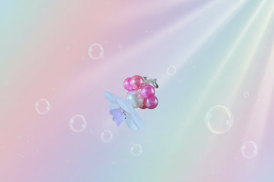 A stunning white flower bead takes centre stage, encircled by shimmering salmon pink pearlescent beads that create a mesmerising spinning effect. The soothing tactile motion helps with focus and stress relief while looking absolutely magical.