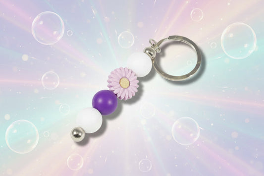 Whether you're keeping track of your keys or adding a decorative touch to your favourite bag, this lovely violet daisy keychain brings a splash of floral charm and personality to your daily routine.