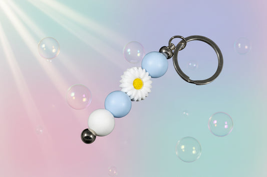 Whether you're keeping track of your keys or adding a decorative touch to your favourite bag, this lovely violet daisy keychain brings a splash of floral charm and personality to your daily routine.