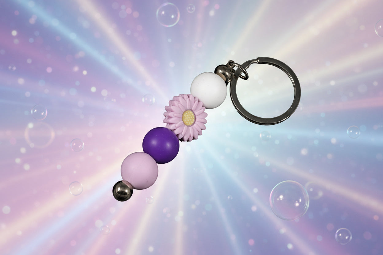 Whether you're keeping track of your keys or adding a decorative touch to your favourite bag, this lovely violet daisy keychain brings a splash of floral charm and personality to your daily routine.