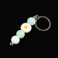 Whether you're keeping track of your keys or adding a decorative touch to your favourite bag, this lovely green daisy keychain brings a splash of floral charm and personality to your daily routine.