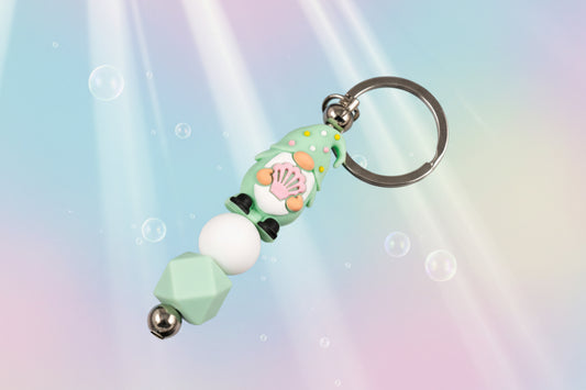 Whether you're keeping track of your keys or adding a magical touch to your favourite bag, this delightful green gnome keychain brings charm, character, and a hint of enchantment to your daily routine.