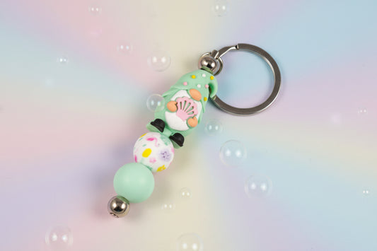 Whether you're keeping track of your keys or adding a magical touch to your favourite bag, this delightful green gnome keychain brings charm, character, and a hint of enchantment to your daily routine.