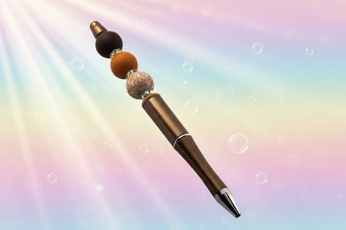 A chocolate brown metallic pen with a brown bead, a terracotta round bead, a floral bead, a fawn oval bead and sparkly Rondelles.