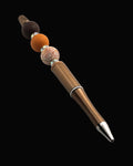 A bronze metallic pen with a brown bead, a terracotta round bead, a floral beada fawn oval bead and sparkly Rondelles.
