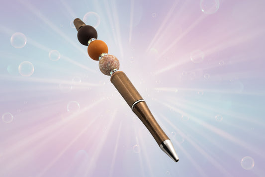 A bronze metallic pen with a brown bead, a terracotta round bead, a floral beada fawn oval bead and sparkly Rondelles.
