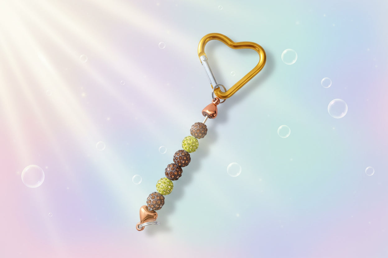 Add a touch of sparkle and love to your everyday essentials with this charming gold heart keychain. Adorned with shimmering beads, this delightful accessory brings personality and joy to your keys, bag, or backpack.