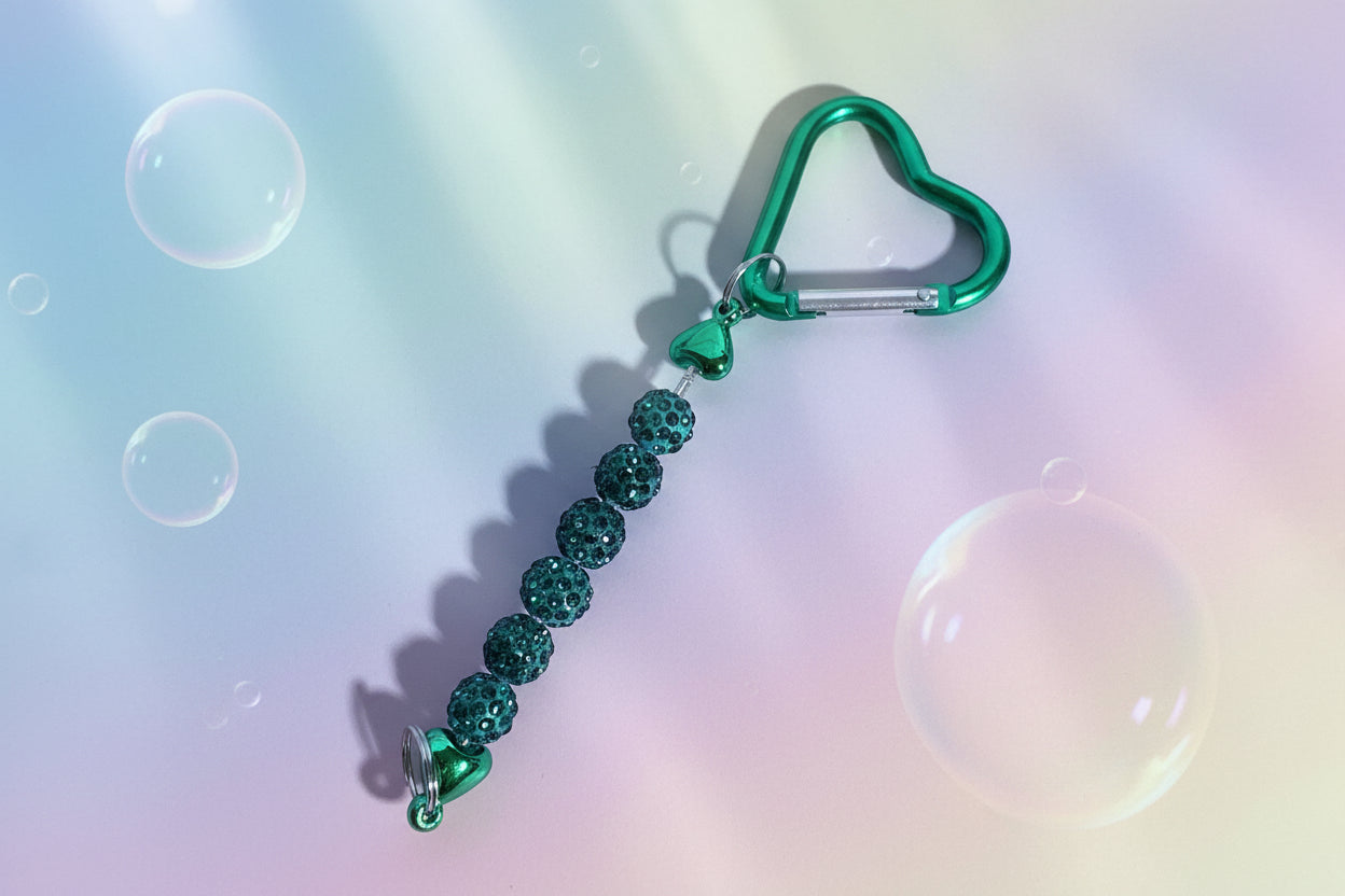 Add a touch of sparkle and love to your everyday essentials with this charming green heart keychain. Adorned with shimmering beads, this delightful accessory brings personality and joy to your keys, bag, or backpack.