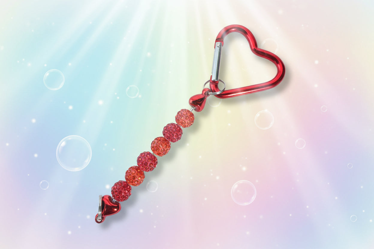 Add a touch of sparkle and love to your everyday essentials with this charming red heart keychain. Adorned with shimmering beads, this delightful accessory brings personality and joy to your keys, bag, or backpack.