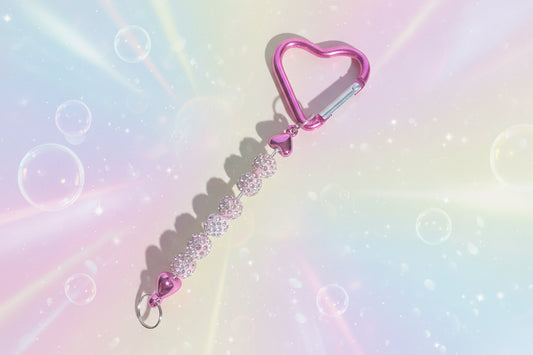 Add a touch of sparkle and love to your everyday essentials with this charming pink heart keychain. Adorned with shimmering beads, this delightful accessory brings personality and joy to your keys, bag, or backpack.