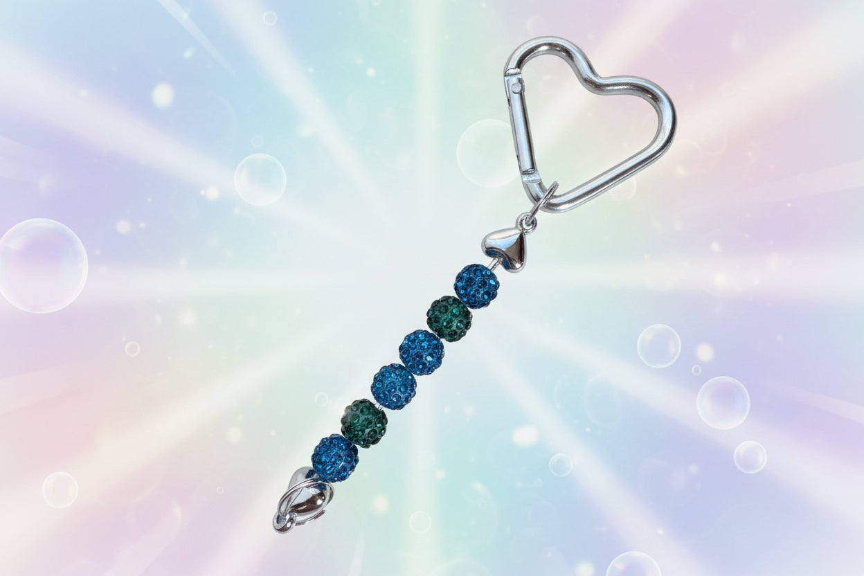 Add a touch of sparkle and love to your everyday essentials with this charming silver heart keychain. Adorned with shimmering beads, this delightful accessory brings personality and joy to your keys, bag, or backpack.