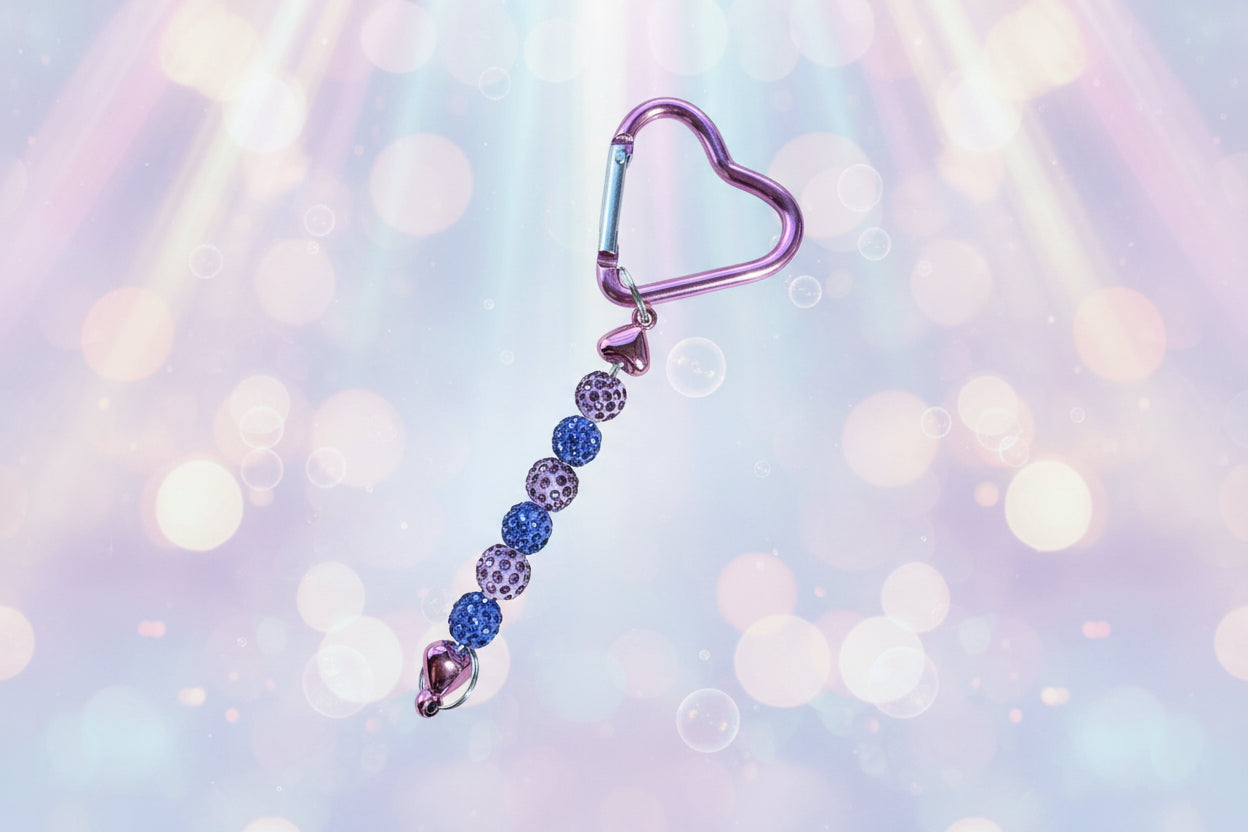 Add a touch of sparkle and love to your everyday essentials with this charming mauve heart keychain. Adorned with shimmering beads, this delightful accessory brings personality and joy to your keys, bag, or backpack.