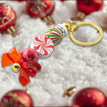 Festive candy cane keychain with red bow charm and red, white and green beads and sparkly rondelle